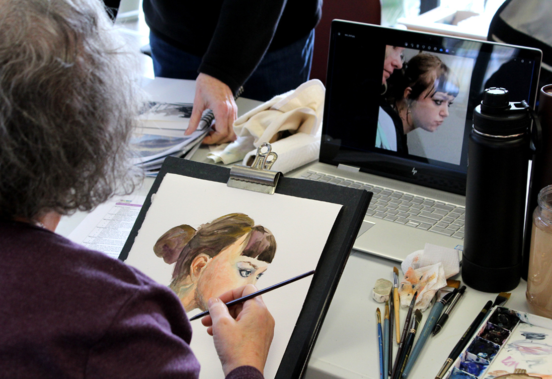 Kim Wessel painting a portrait.